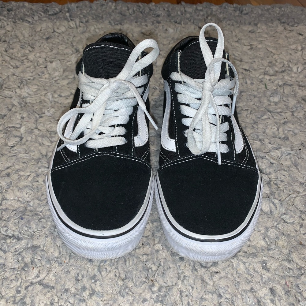 Black and white low top vans